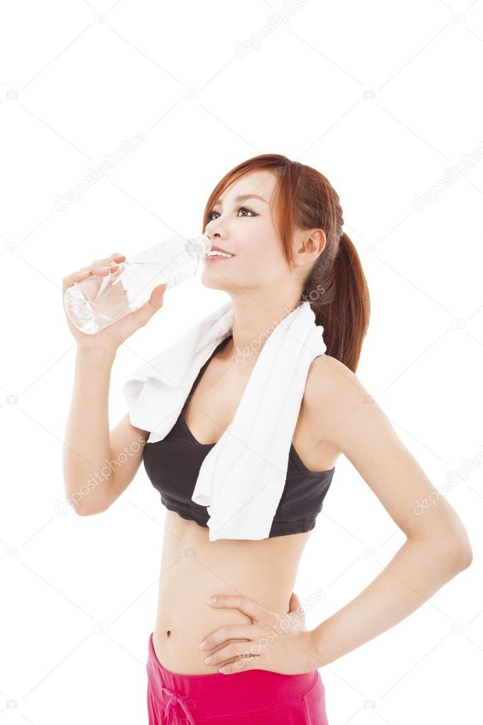 sporty young woman drinking water after workout