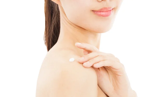 Shoulder of young woman applying moisturize cream — Stock Photo, Image