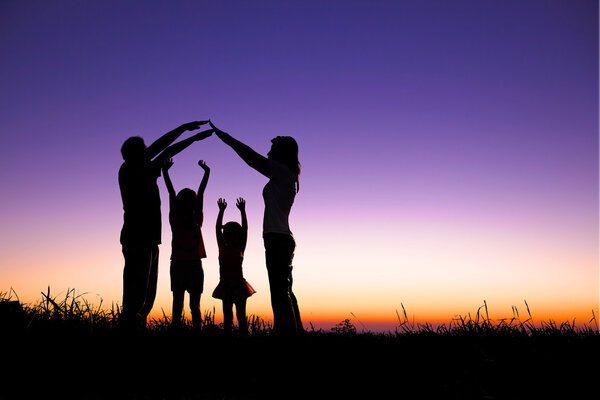 Happy family making the home sign on the hill — Stock Photo, Image