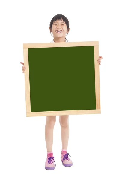 Happy little girl holding blank chalkboard — Stock Photo, Image
