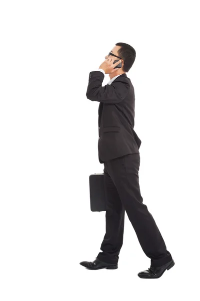 Business man walking and talking on the phone — Stock Photo, Image