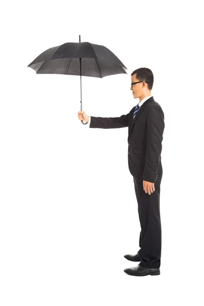 Smiling businessman holding umbrella standing — Stock Photo, Image