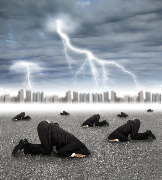 Scared businessman hiding on the ground with storm coming — Stock Photo, Image
