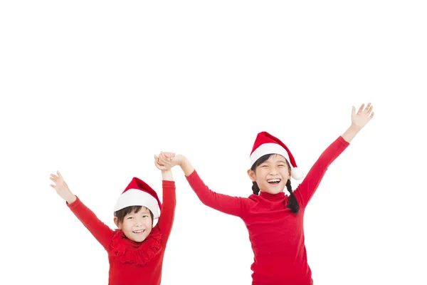 Fröhliche kleine Mädchen mit roten Weihnachtsmützen — Stockfoto