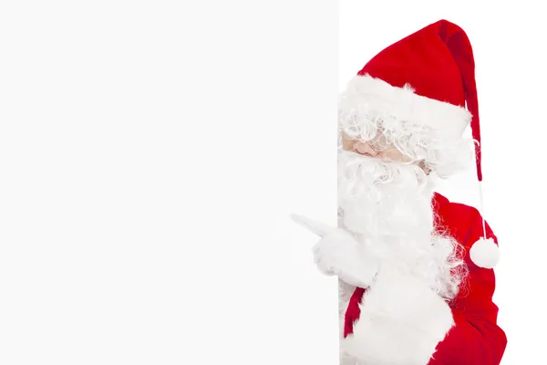 Happy Santa Claus pointing at blank banner — Stock Photo, Image