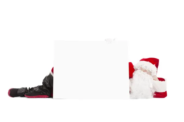 Happy Santa Claus lying with blank banner — Stock Photo, Image
