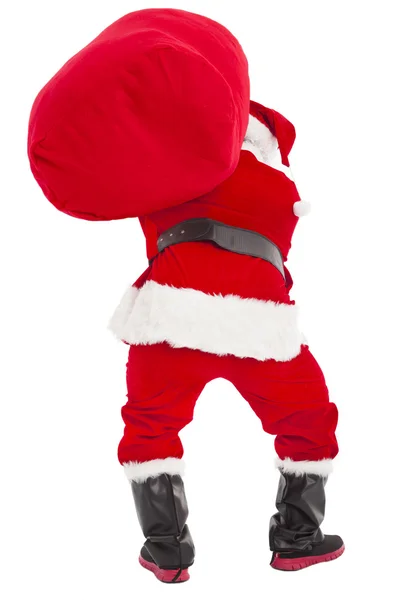 Santa claus zware geschenk draagtas — Stockfoto