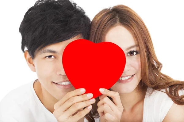 Sonriente pareja sosteniendo el signo de amor —  Fotos de Stock