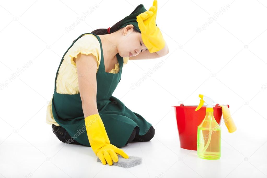 tired Service woman cleaning the floor