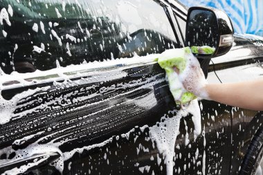 hands hold sponge for washing car clipart