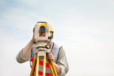 Surveyor engineer making measure with cloud background clipart