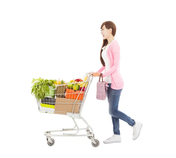 Happy young woman with shopping cart — Stock Photo, Image