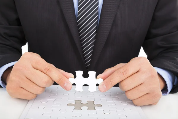 Businessman holding a jigsaw — Stock Photo, Image