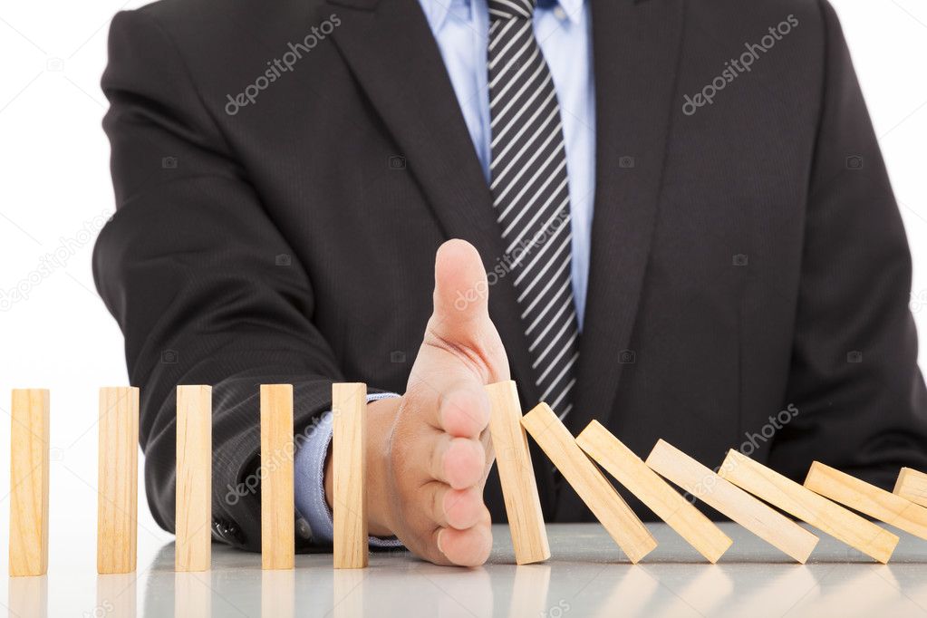 businessman hand stop dominoes continuous toppled