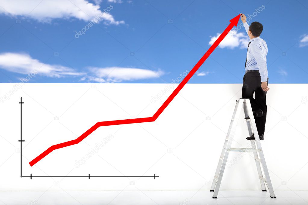 businessman standing on ladder drawing global diagrams