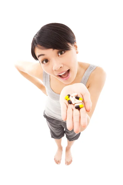 Portrait of young happy smiling woman showing vitamin — Stock Photo, Image