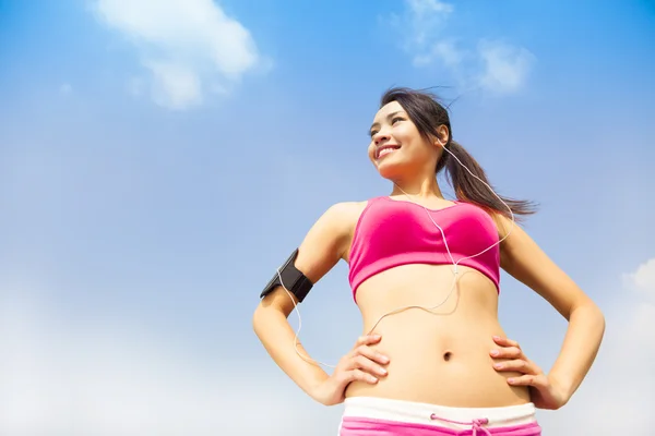 Running woman jogging outdoors listening to music Stock Image