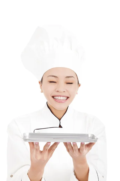 Pretty woman chef smell something on tray — Stock Photo, Image