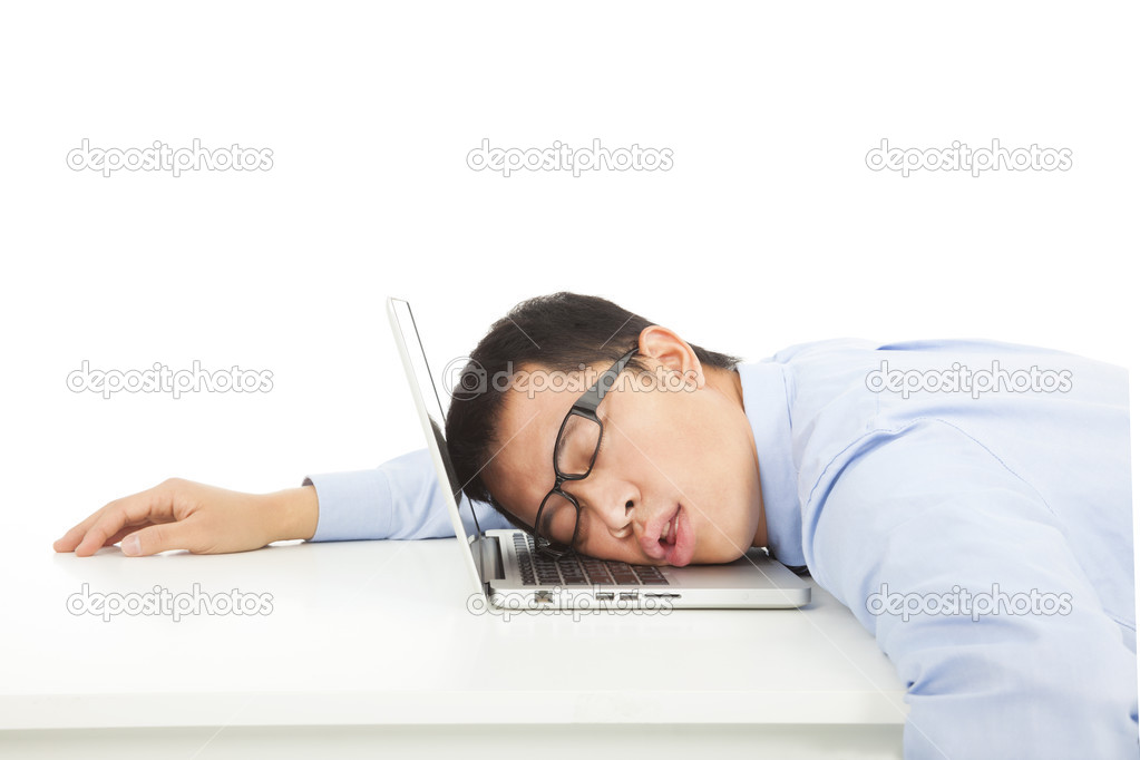 Tired overworked businessman sleeps on laptop