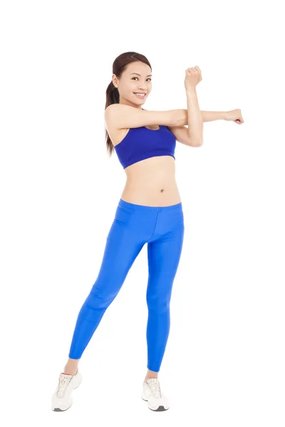Beautiful fit woman stretching her arm and smiling — Stock Photo, Image