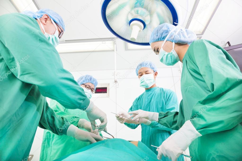 Team surgeon working in operating room.