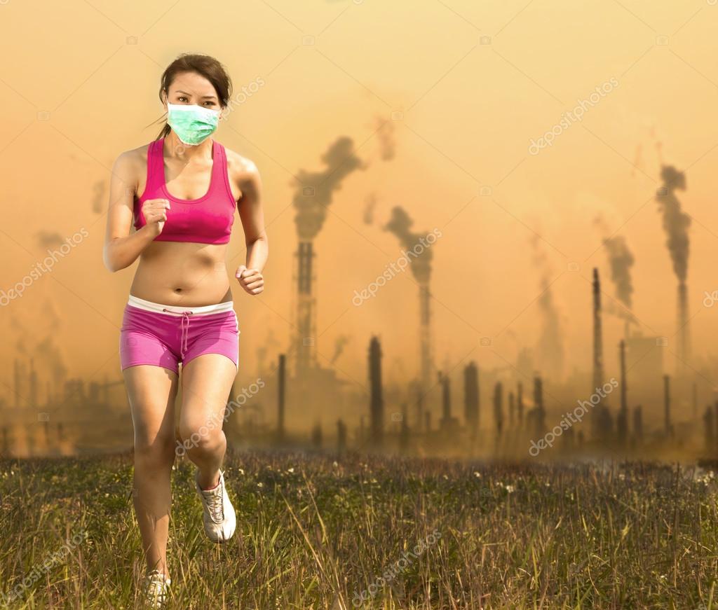 Woman was wearing a mask and running on air pollution Stock Photo by  ©tomwang 41356785