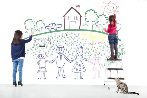 Two kids drawing their dream on the white wall — Stock Photo, Image