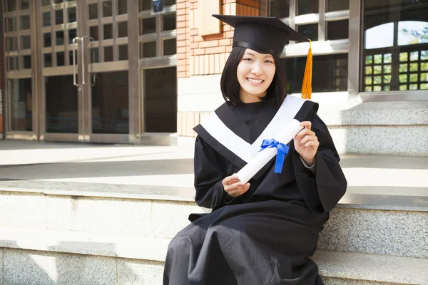 Asian college student holding a diploma at campus — Stock Photo, Image