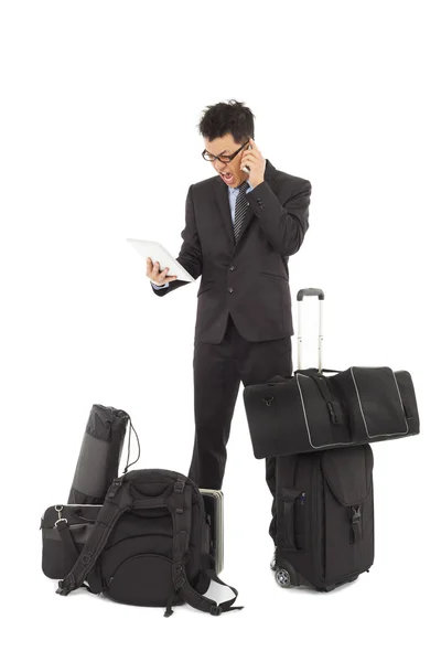 Angry businessman talking on the phone and holding a tablet — Stock Photo, Image