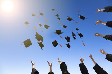 happy young graduates throwing hats clipart