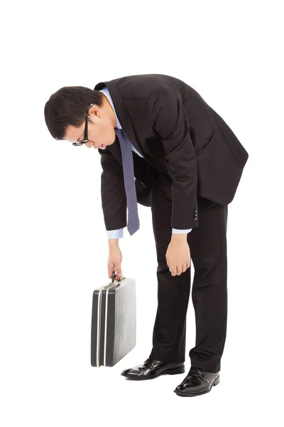 Very tired businessman stoop and holding briefcase Stock Picture