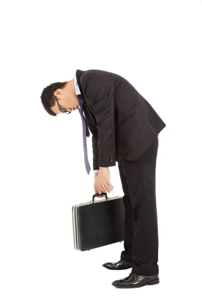 Exhausted businessman stoop and holding briefcase Royalty Free Stock Images