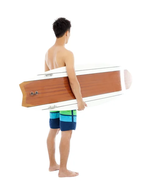 Мальчик держит доску для серфинга на белом фоне — стоковое фото