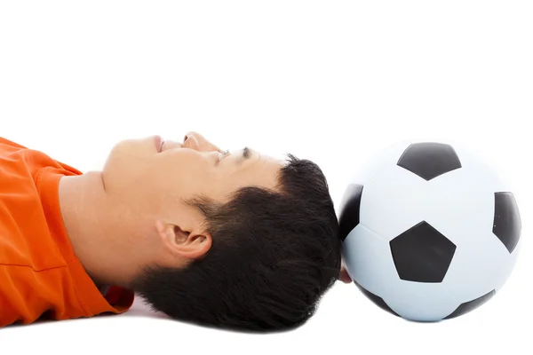 Jonge man liggen en denken met soccer — Stockfoto