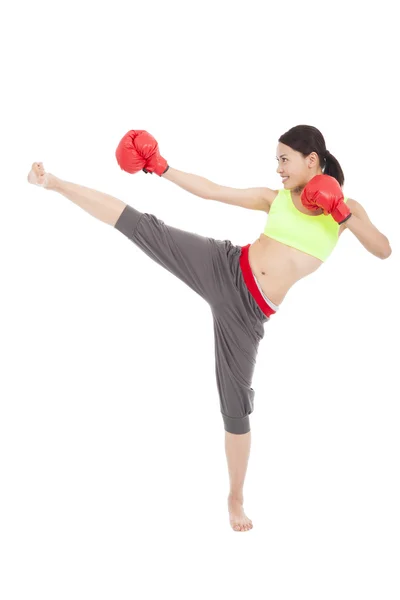 Pretty sporty woman is kicking and punching — Stock Photo, Image