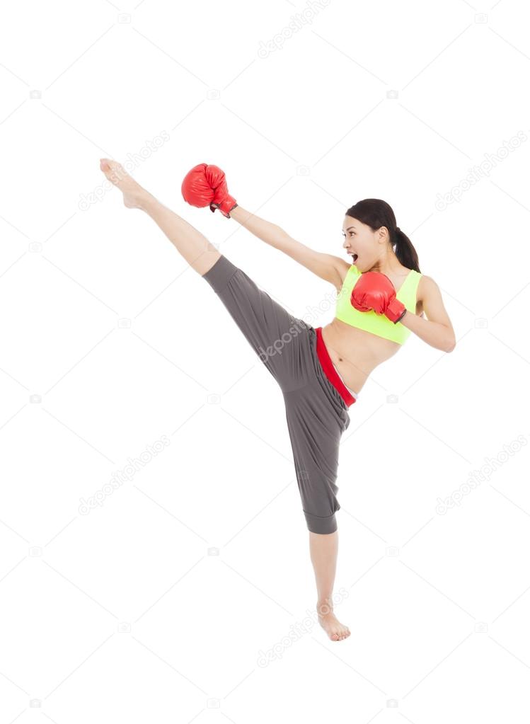 pretty female boxer  is kicking and punching