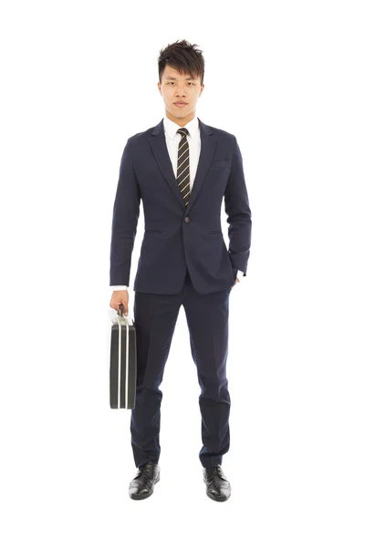 Businessman holding a briefcase and hand in his pocket — Stock Photo, Image