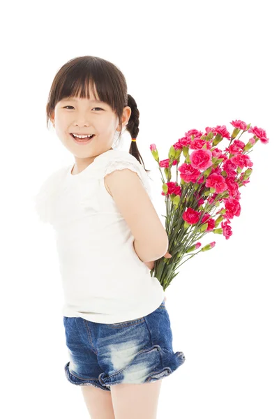 Smiling girl hiding a bouquet of carnations — Stock Photo, Image