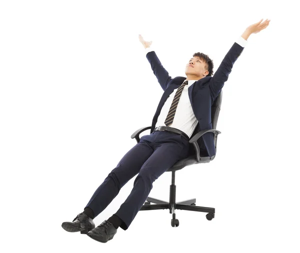 Relax businessman sitting on a chair and raise hands — Stock Photo, Image