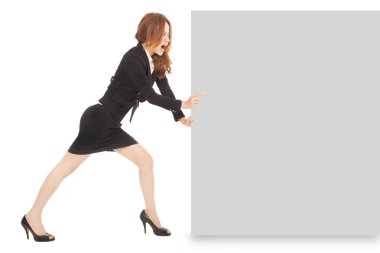 Young businesswoman pushing a blank board on white background clipart