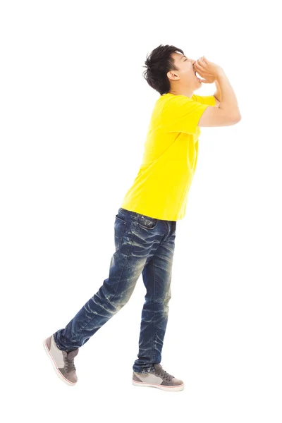 Young man walking while raising hands to yell — Stock Photo, Image