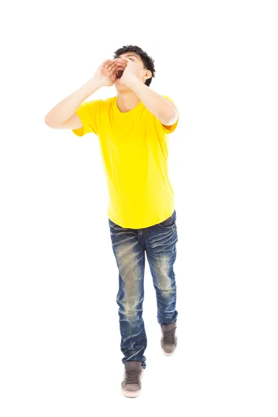 Young man walking while raising hands to yell — Stock Photo, Image