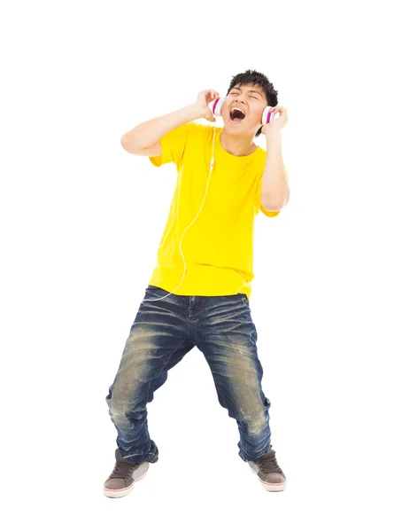 Young man singing  while listening music — Stock Photo, Image