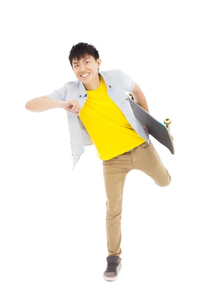 Vibrant young man holding a skateboard and make a pose — Stock Photo, Image