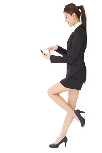 Pretty young businesswoman touching smart phone — Stock Photo, Image