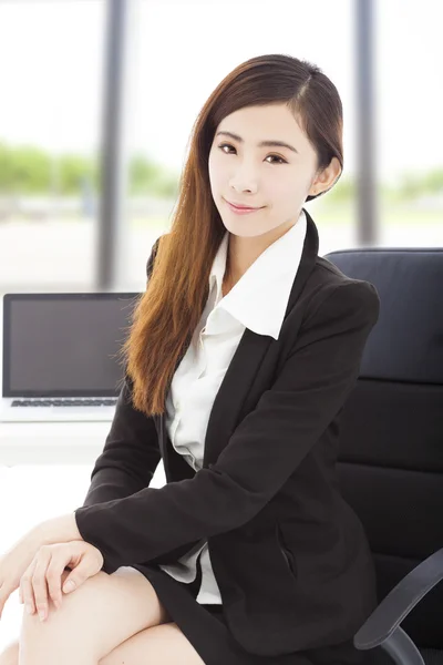 Young confident businesswoman sitting in her office — Stock Photo, Image