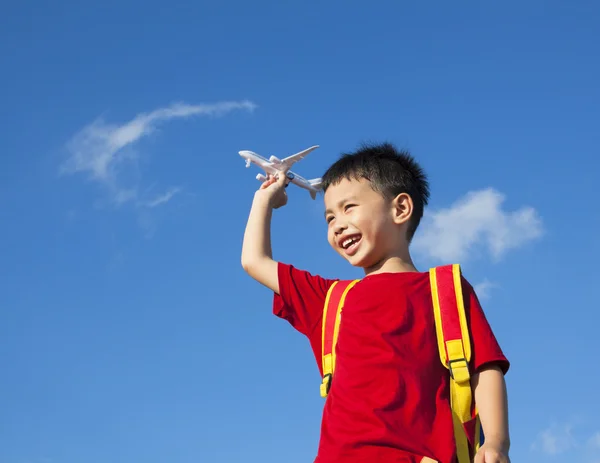 Little boy holding a airplane toy with a backpack — Stock Photo, Image