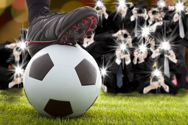 Many photographer taking winner soccer player feet on field — Stock Photo, Image