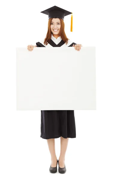 Happy young female graduation students with blank board — Stock Photo, Image