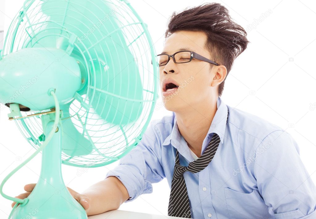 Young business man use fans to cool down